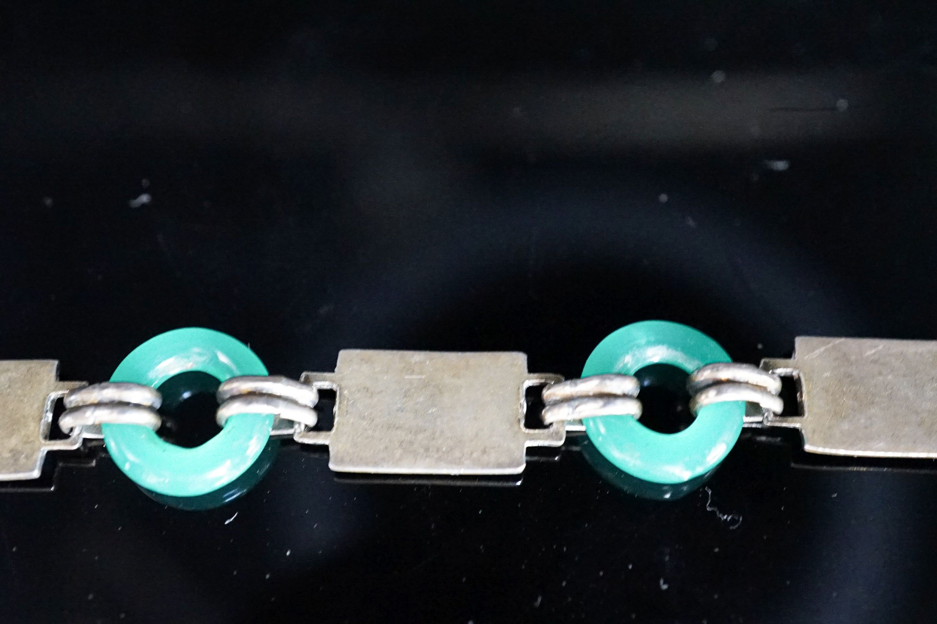 A 20th century Egyptianesque gilt white metal, enamel and chrysoprase loop set bracelet, 18cm.